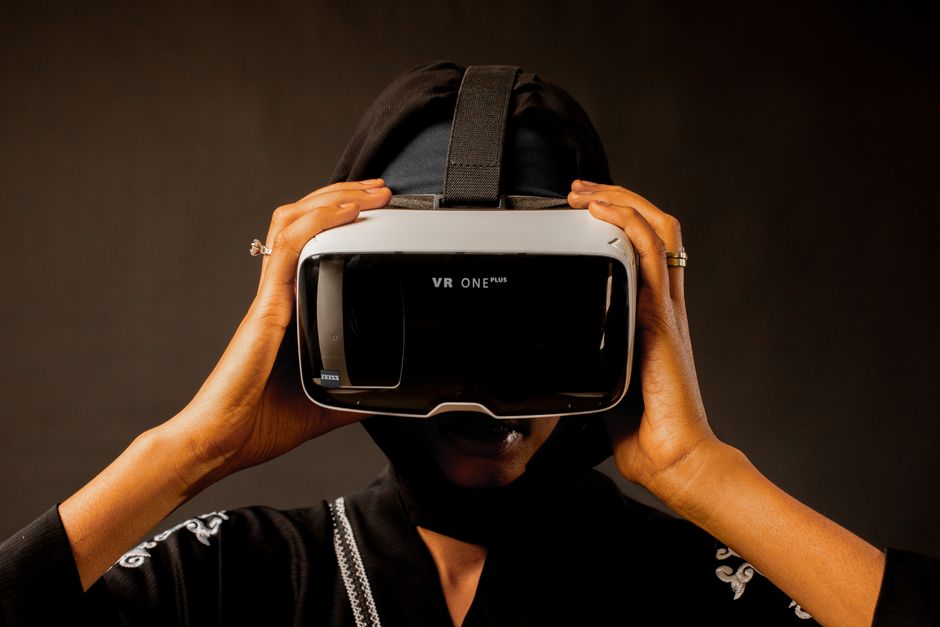 Woman using a VR headset, immersed in a virtual reality experience.